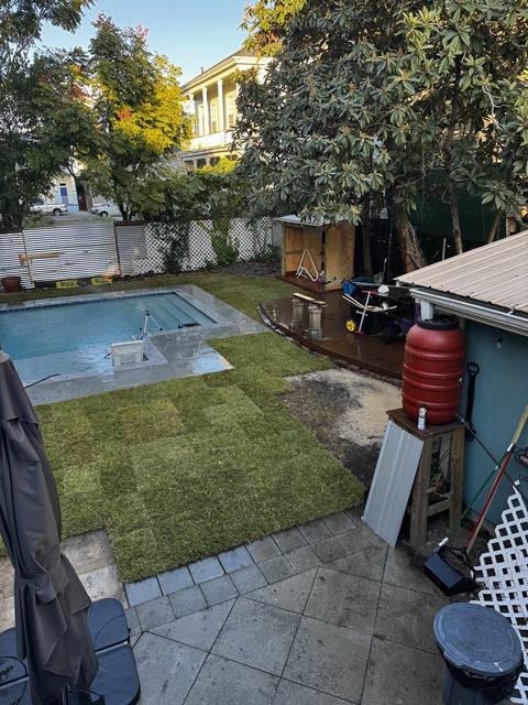 Fresh sod laid around a plunge pool and a slate patio